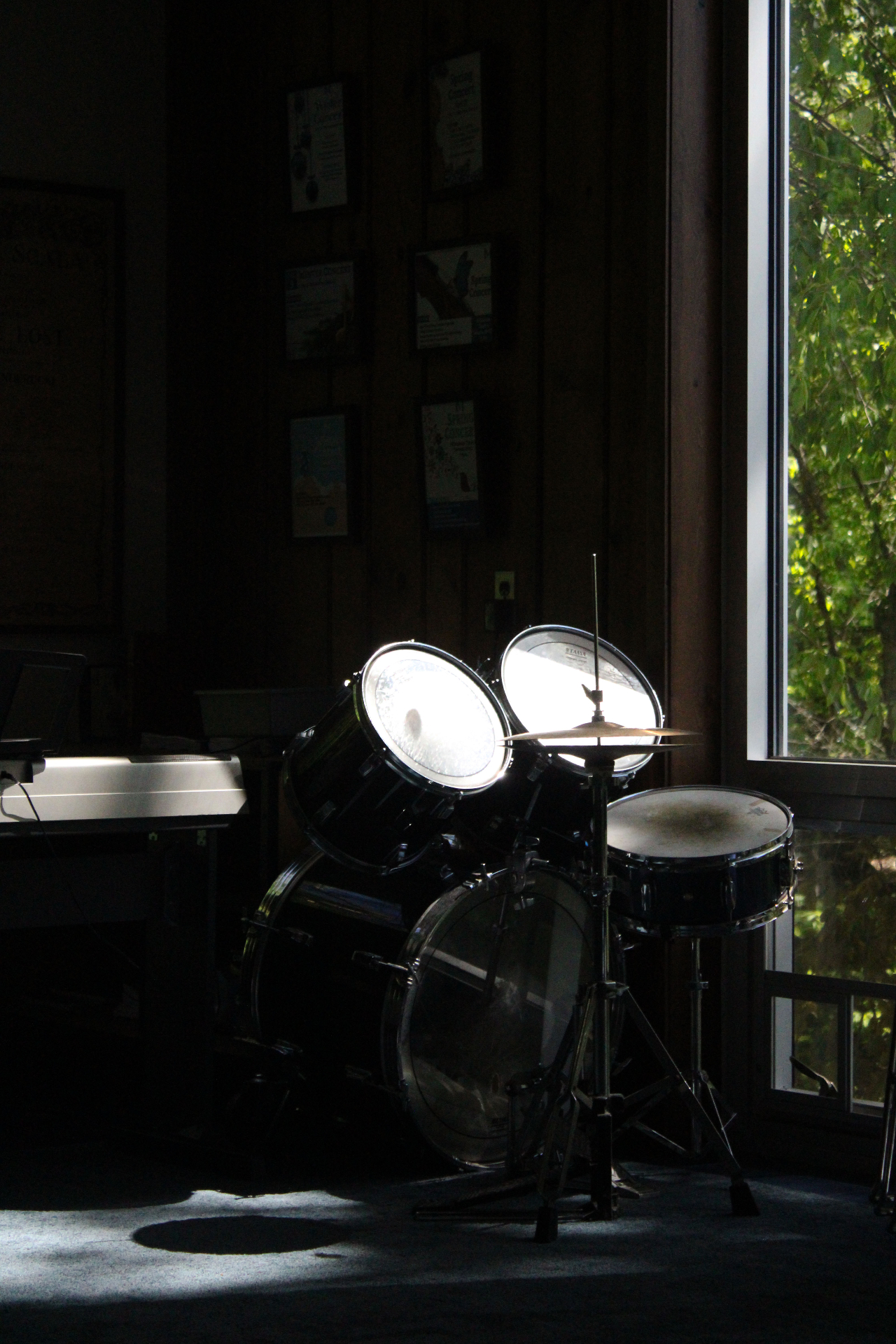 Drum kit in a shaft of light, negative space study
